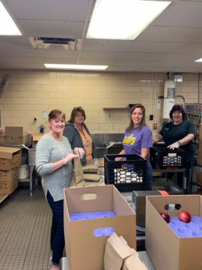 District staff packing lunches in school's kitchen.