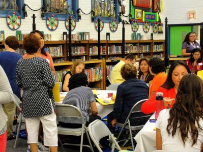 Teachers and staff gathered for an event in a library