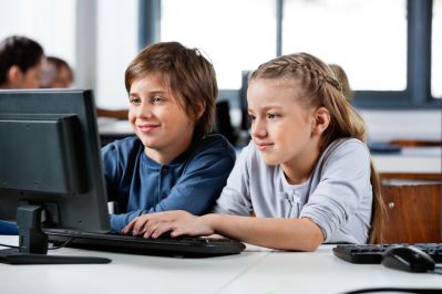 Two students sitting in front of a computer