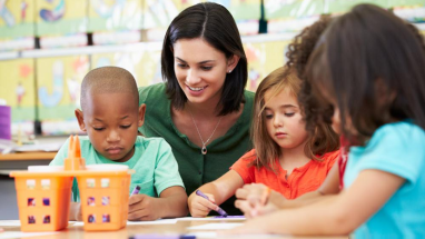 Photo of teacher working with students