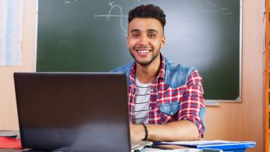 Student typing on computer