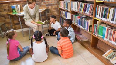 Librarian with students in library