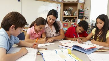 Teacher working with group of students in classroom