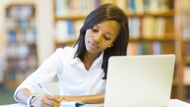 college student studying at computer