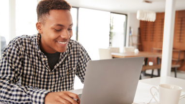 student at computer at home