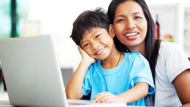 happy parent and child at a computer