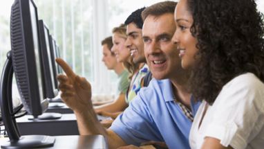High school students in computer lab with teacher