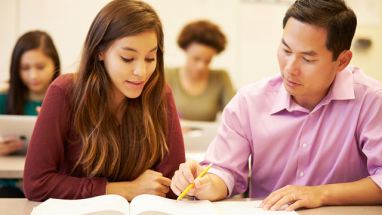 high school teacher with student