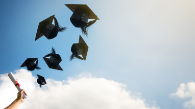 graduation caps and diploma