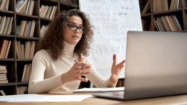 teacher teaching class on a computer