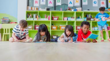 young students on classroom floor